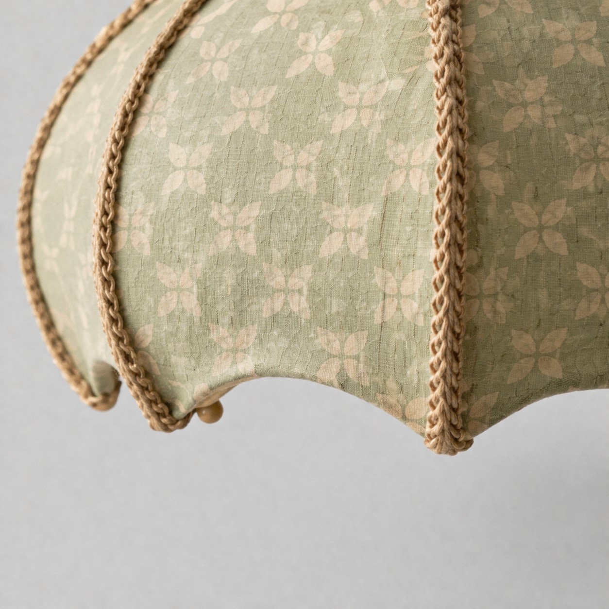 Sage floral fabric shade curved edge and trim detail