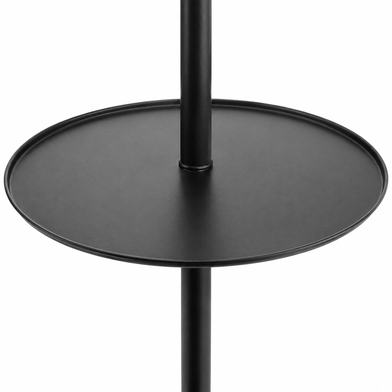 Close-up of the round black side table attached to the floor lamp stand