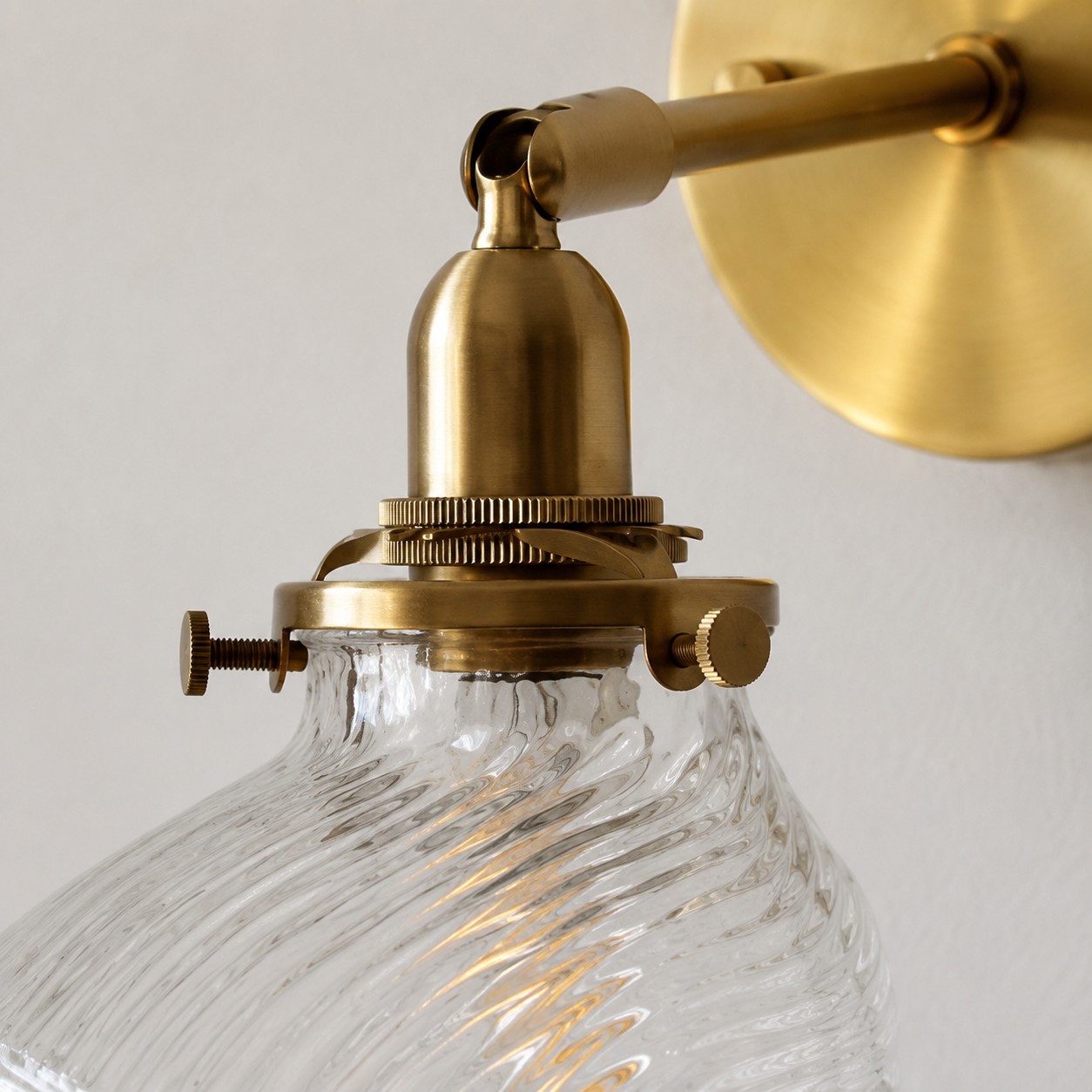 Clear ribbed glass shade and brass holder detail