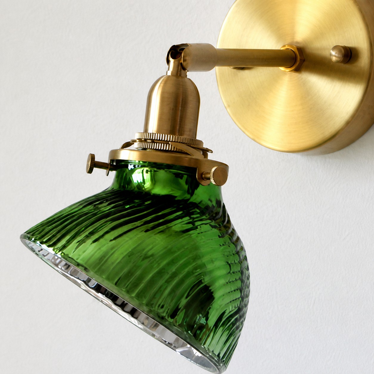 Green ribbed glass shade and brass holder detail
