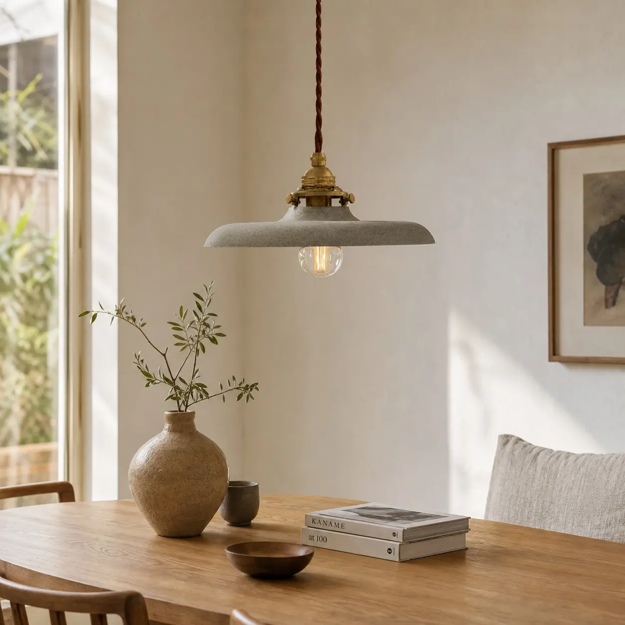 Distressed silver pendant light above a dining table