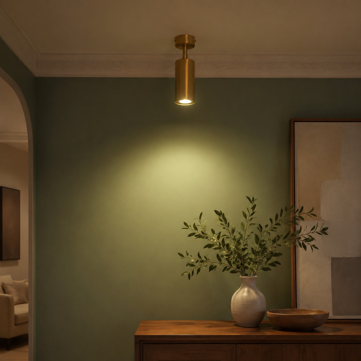 Brass ceiling spotlight installed above a console wall