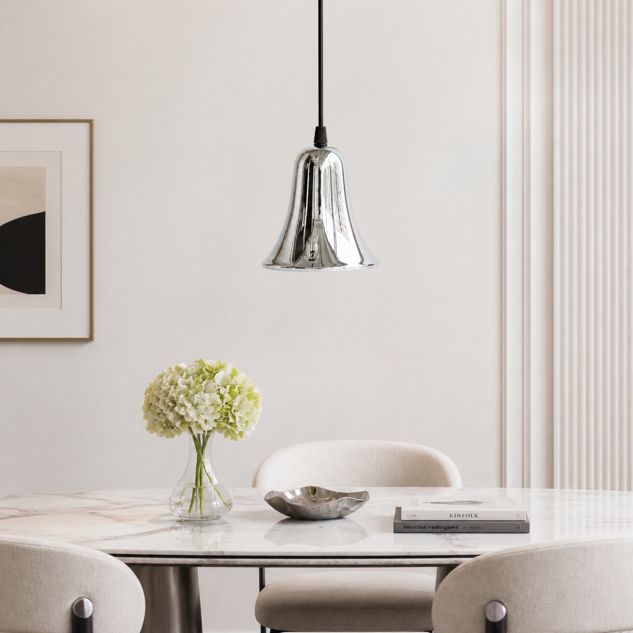 Bell-shaped chrome pendant light in a bright dining space